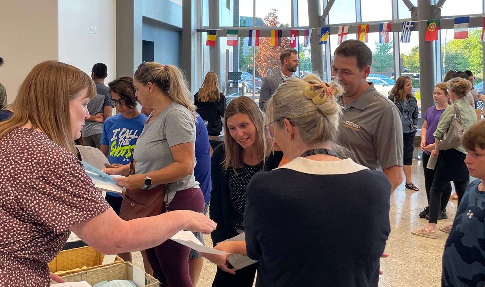 Parents, teachers and students celebrating together in the lobby.