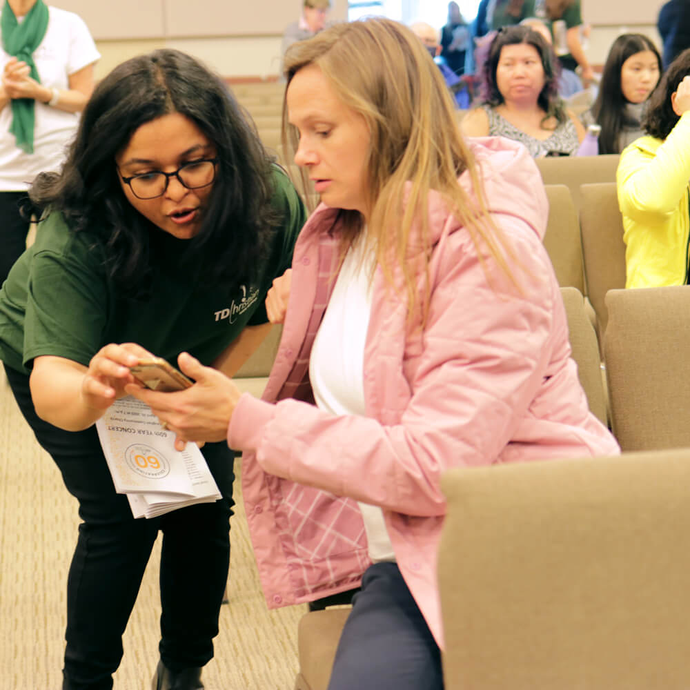 Parent and high school teacher reviewing something together.
