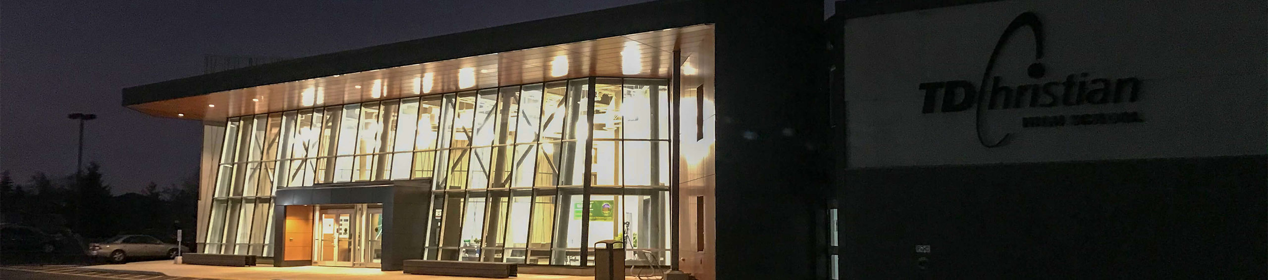 Photo of the exterior of the school lit up at night