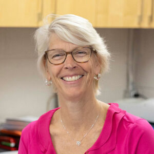 Photo of a woman with glasses smiling