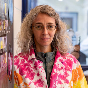 Photo of a woman in a brightly coloured lab coat