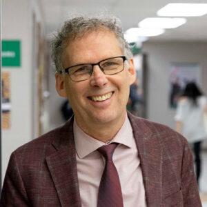 photo of a man ina. suit smiling