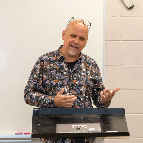 Teacher in classroom giving a lesson.