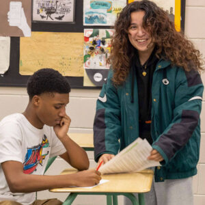 Two students working together at desk.